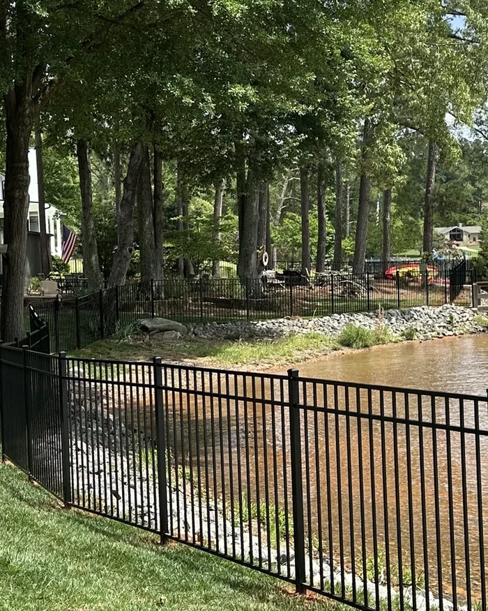 A white vinyl privacy fence with a matching gate